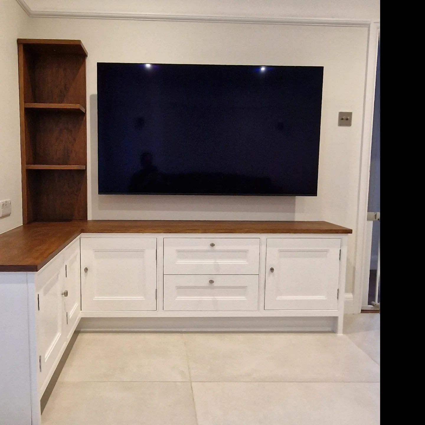 Fitted media wall and storage in navy